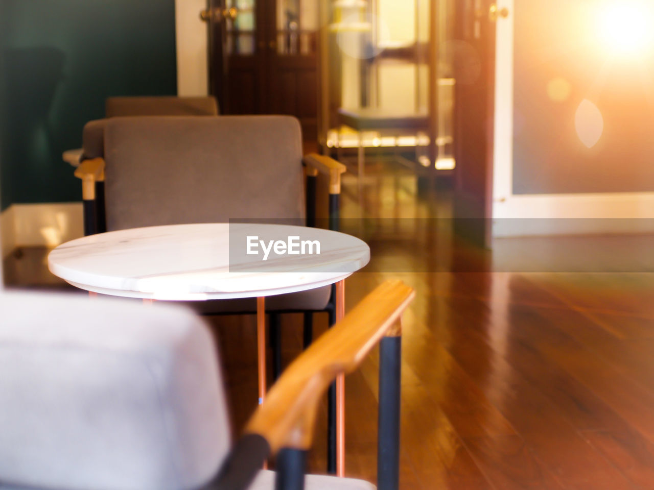 EMPTY CHAIRS AND TABLE AT CAFE