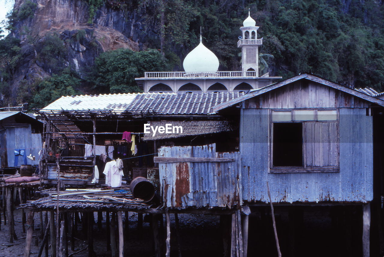 Huts and mosque against mountain