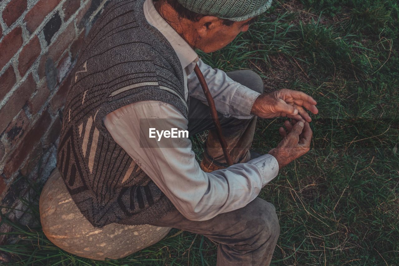 High angle view of man sitting on grass 