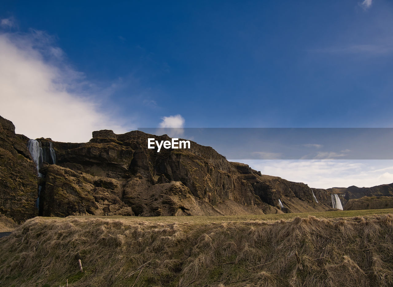 SCENIC VIEW OF LAND AND MOUNTAINS AGAINST SKY