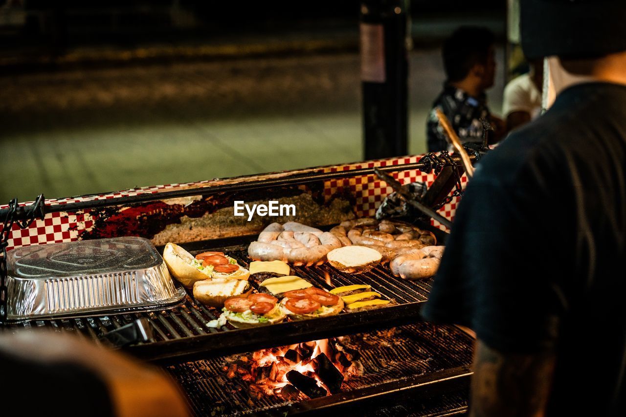 Midsection of man preparing food on grill