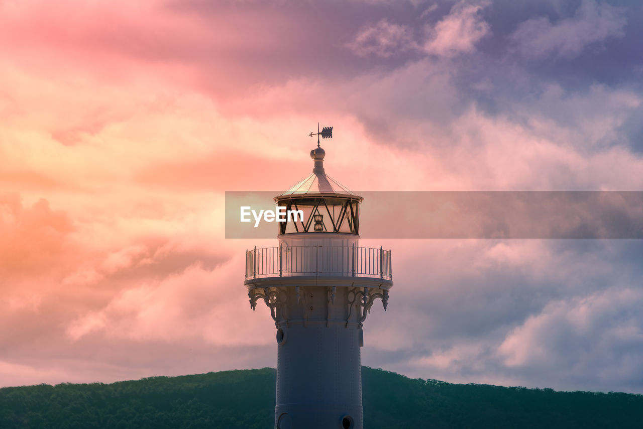 Lighthouse against sky during sunset