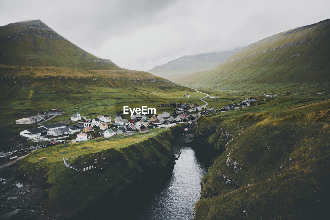 Scenic view of faroe islands against cloudy sky