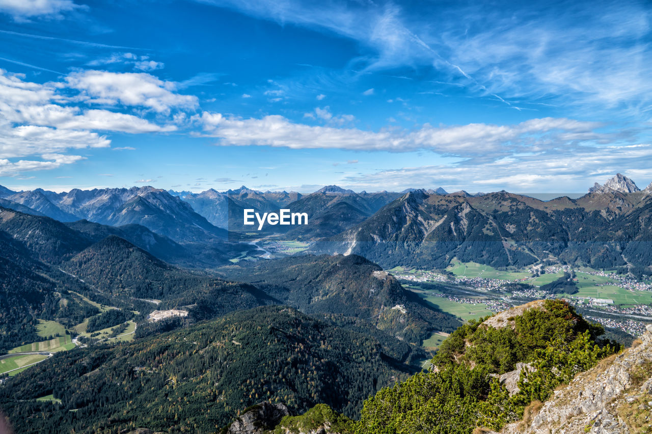 Scenic view of mountains against blue sky