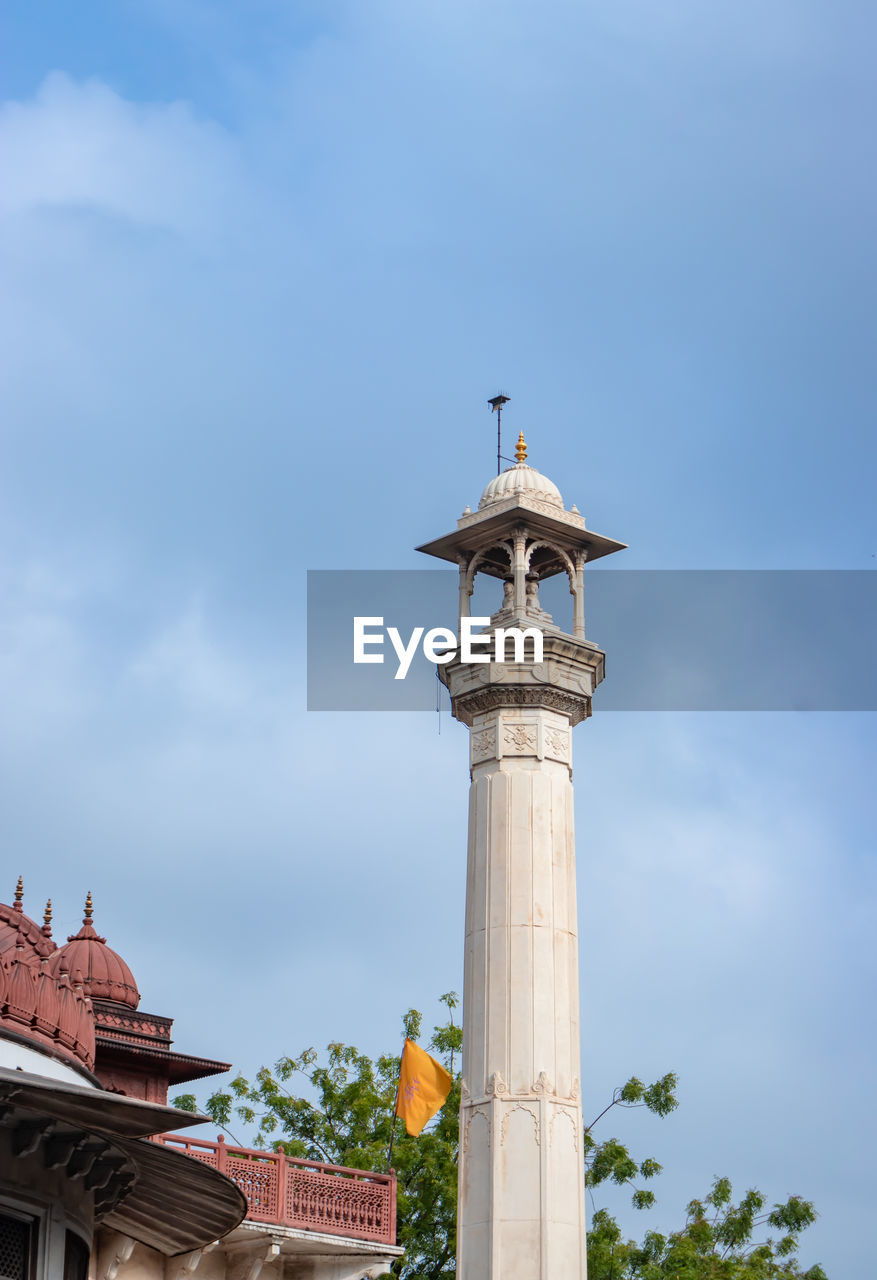 Ancient artistic holy jain temple holy pillar with cloudy sky at morning