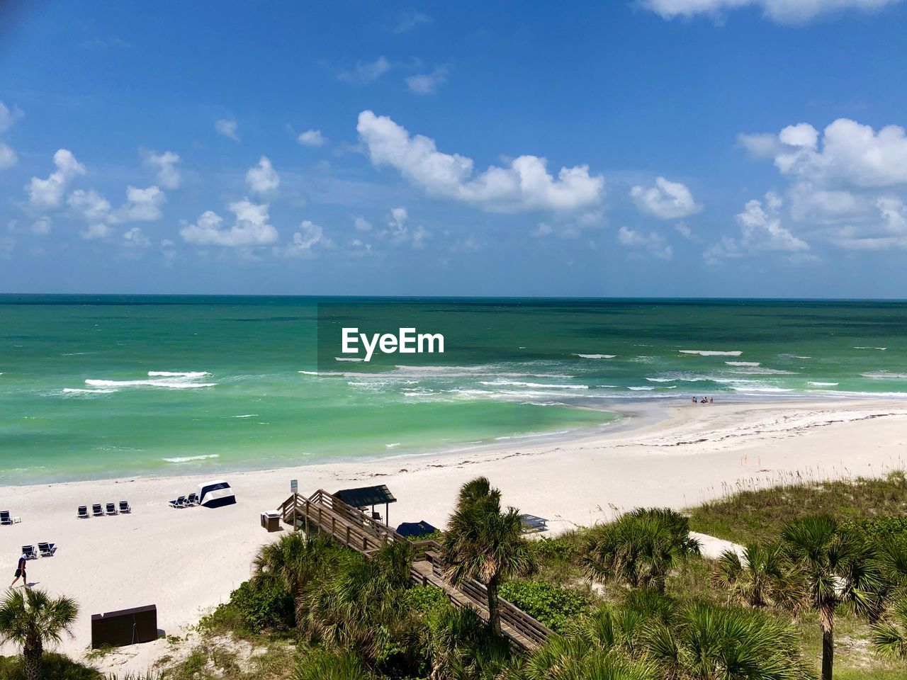 SCENIC VIEW OF BEACH AGAINST BLUE SKY