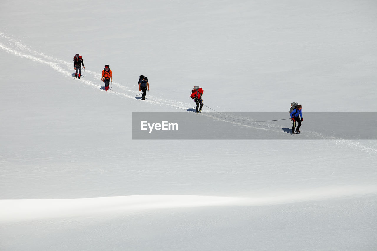 PEOPLE ON SNOWCAPPED MOUNTAIN