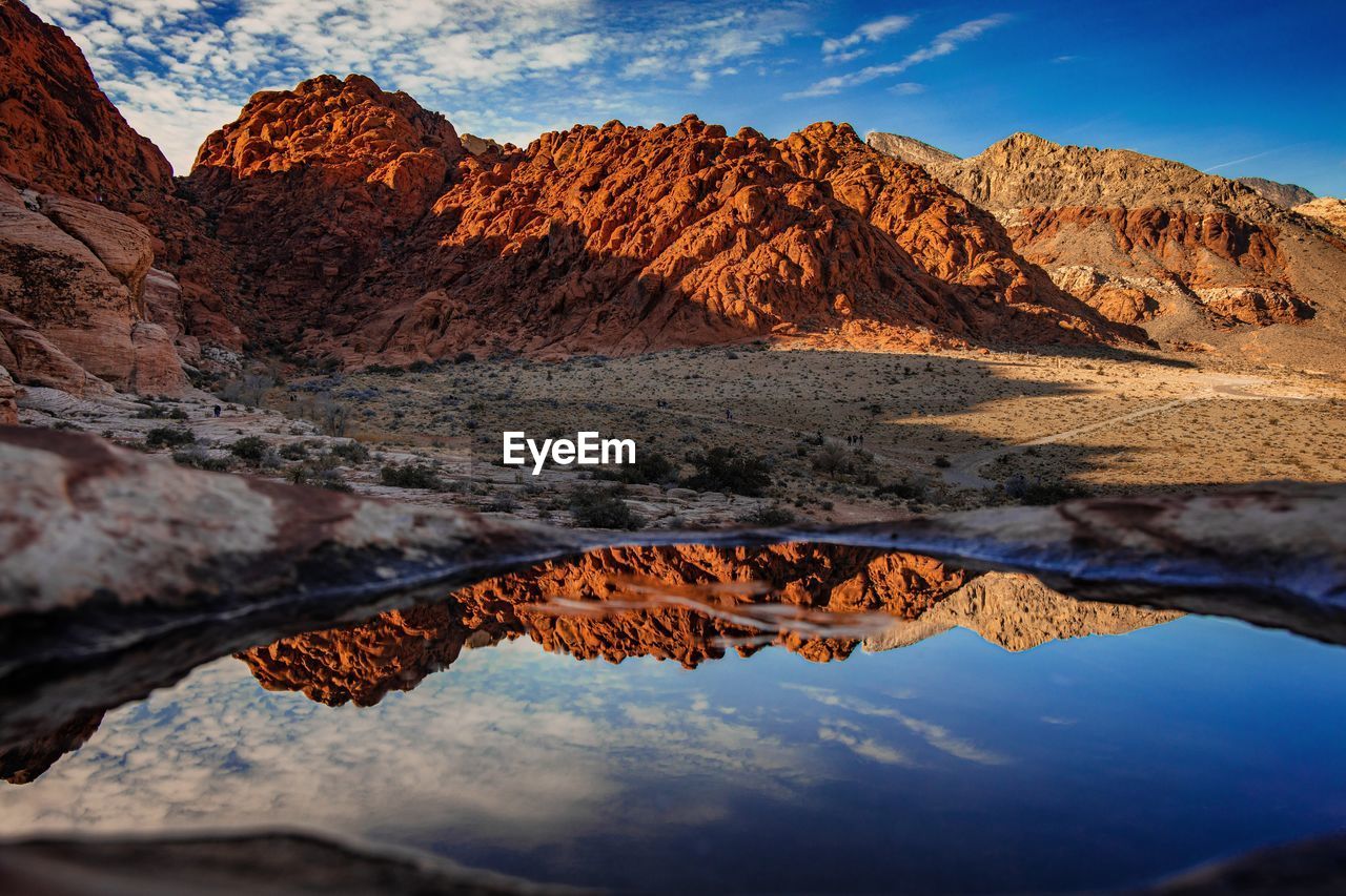 Scenic view of mountains against cloudy sky