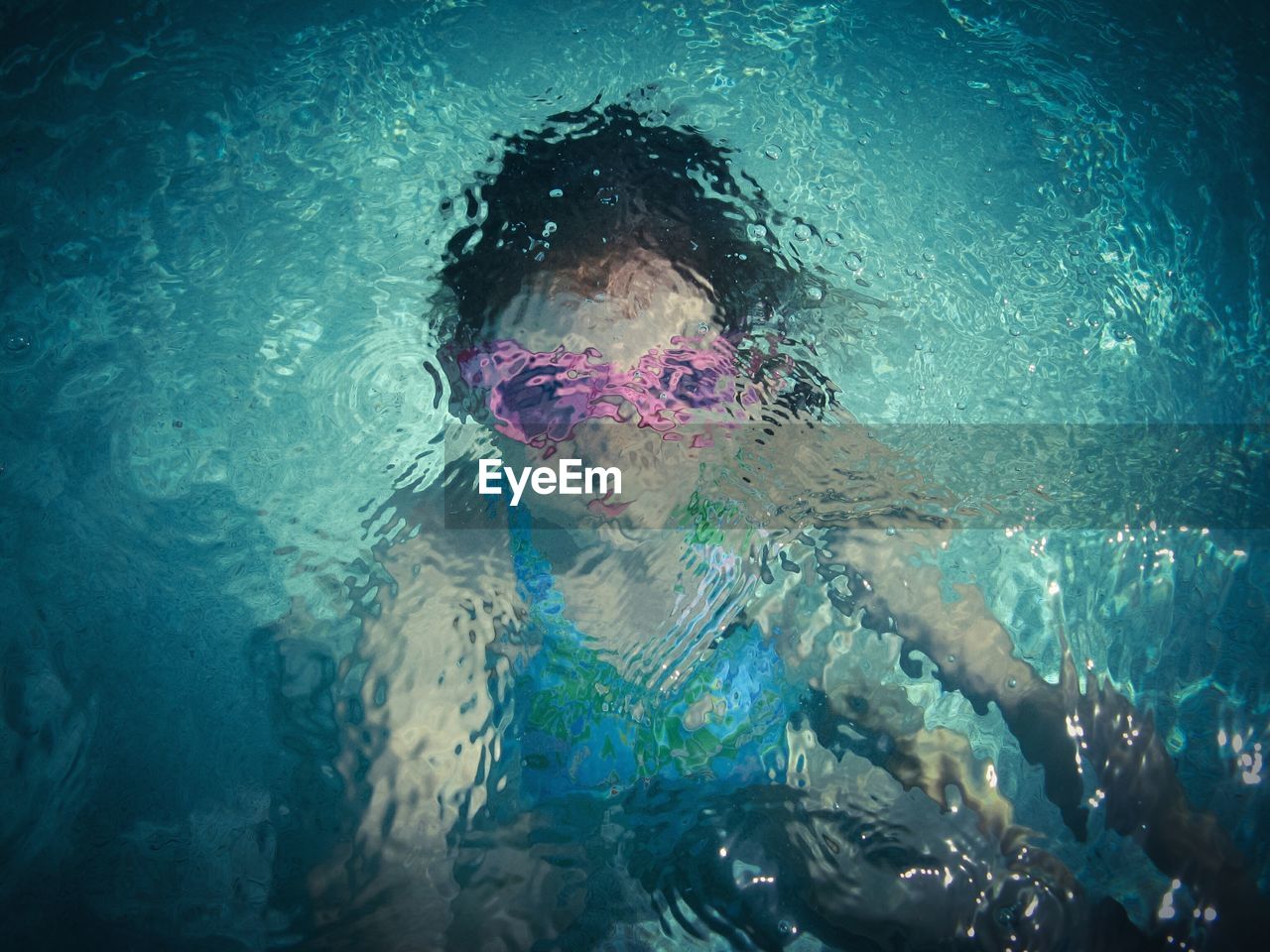 High angle view of girl in rippled swimming pool