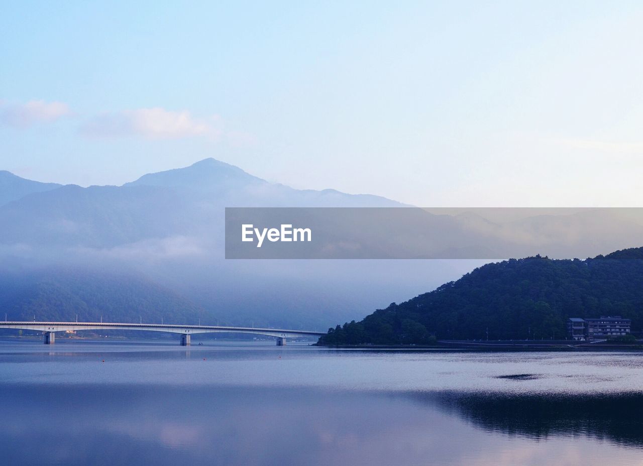 Bridge over lake kawaguchi against sky