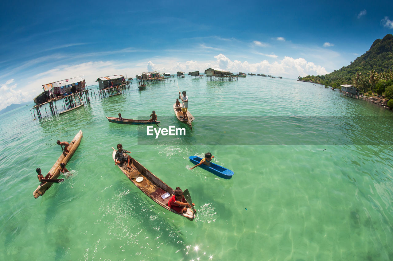 HIGH ANGLE VIEW OF PEOPLE ON SEA