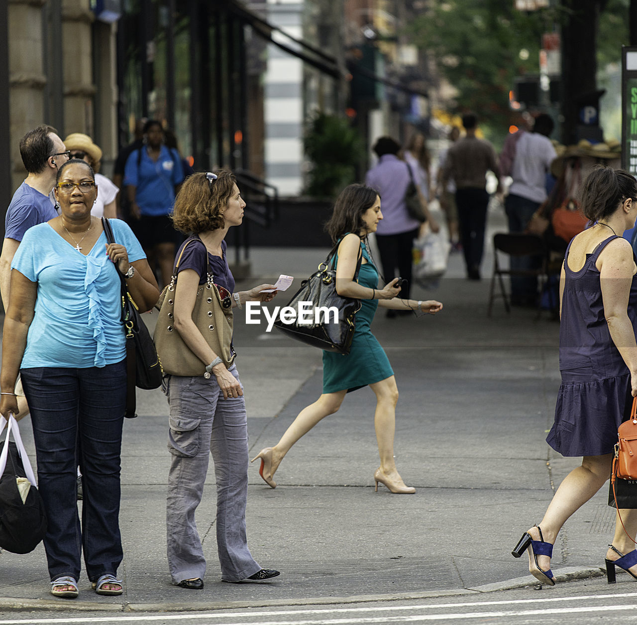 REAR VIEW OF PEOPLE WALKING IN CITY