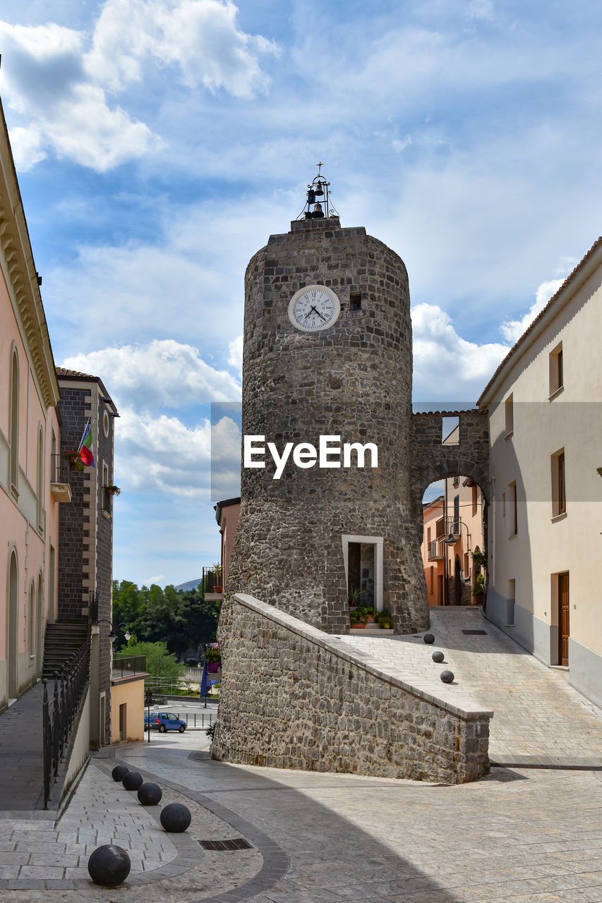 architecture, building exterior, built structure, building, sky, town, cloud, history, the past, tower, travel destinations, city, nature, street, day, religion, travel, clock, no people, place of worship, outdoors, tourism, bell tower, clock tower, old