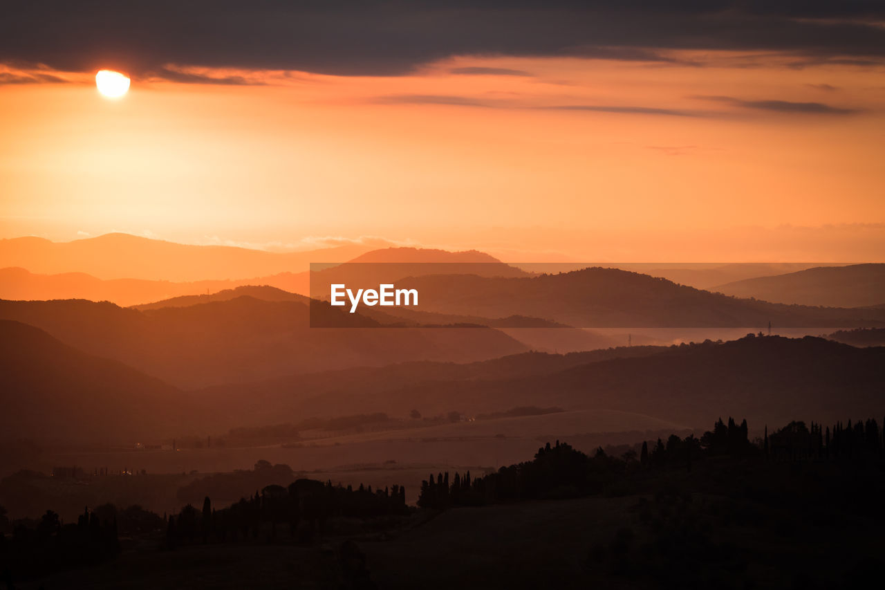 Scenic view of silhouette mountains against sky at sunset