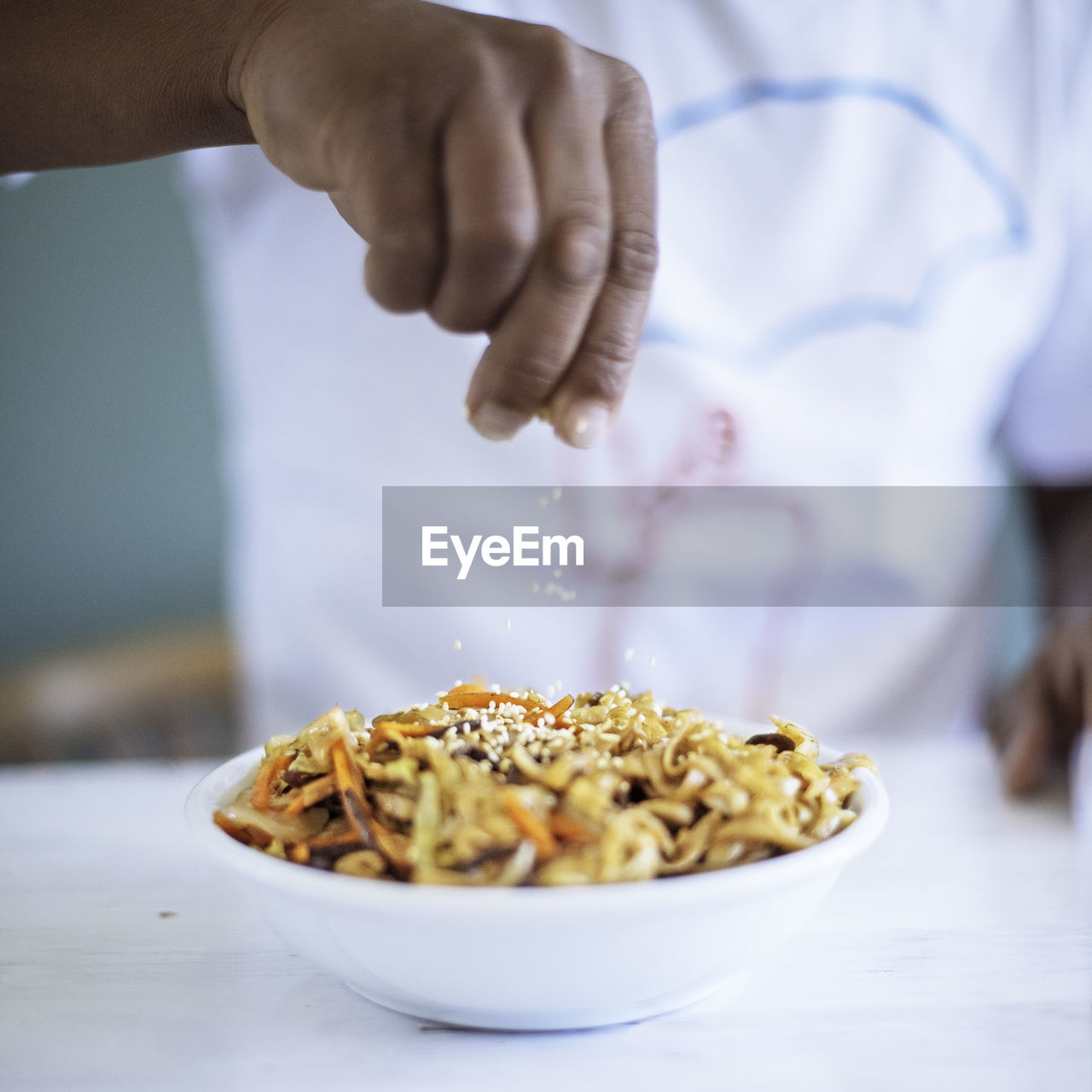 Close-up of person preparing food in bowl on table