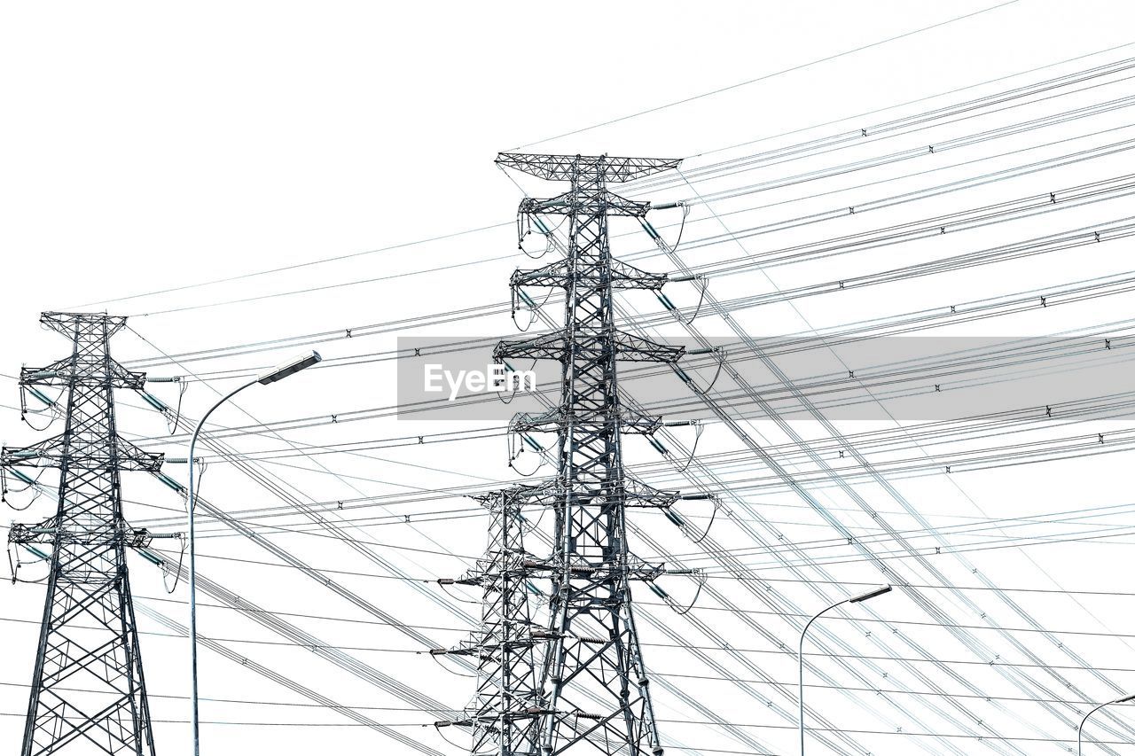 Low angle view of electricity transmission power pylon against clear sky