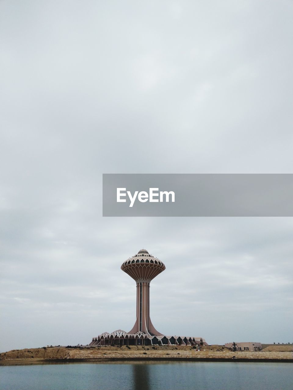 LIGHTHOUSE AMIDST SEA AGAINST SKY