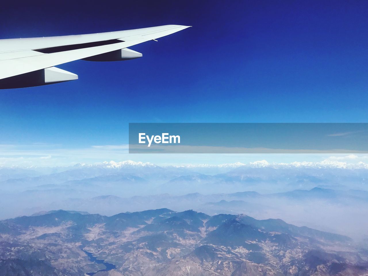 Aerial view of mountains against blue sky