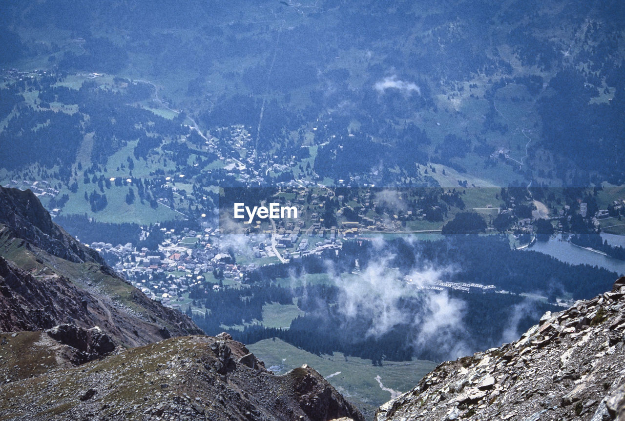 HIGH ANGLE VIEW OF AERIAL SHOT OF LAND AND MOUNTAINS