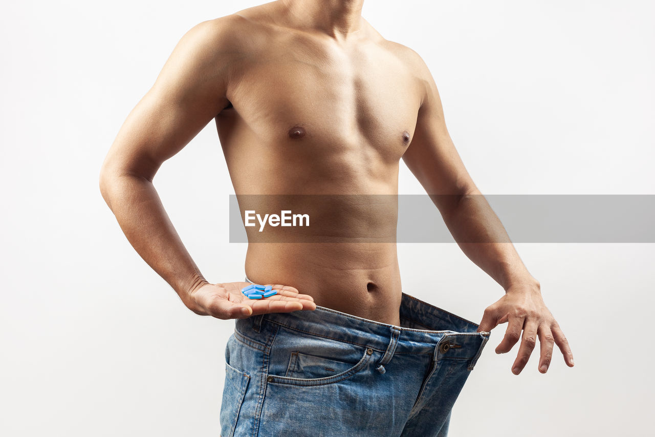 jeans, adult, men, studio shot, muscular build, one person, clothing, white background, lifestyles, arm, strength, indoors, undergarment, young adult, cut out, casual clothing, standing, briefs, underpants, wellbeing, vitality, human muscle, torso, person, relaxation, barechested, textile, midsection, copy space