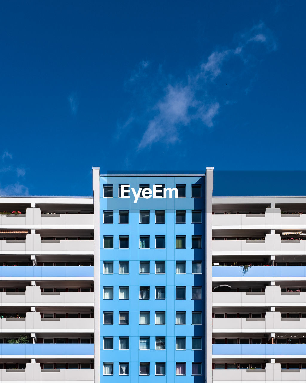 Low angle view of modern building against blue sky