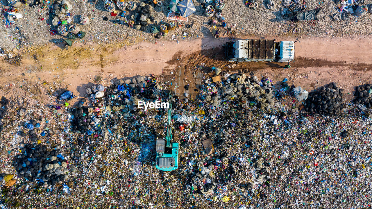 Garbage pile in trash dump or landfill, aerial view garbage trucks unload garbage to a landfill,