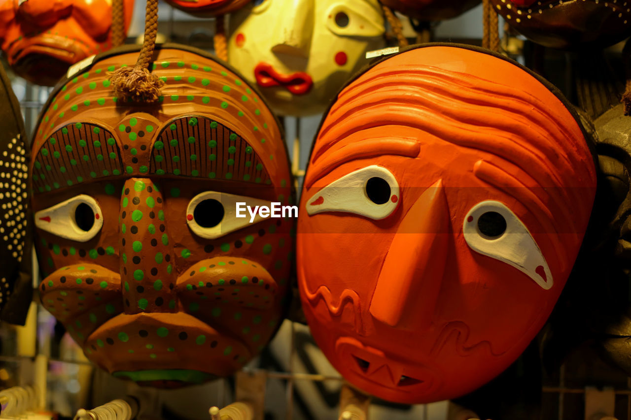 Close-up of masks for sale at market stall