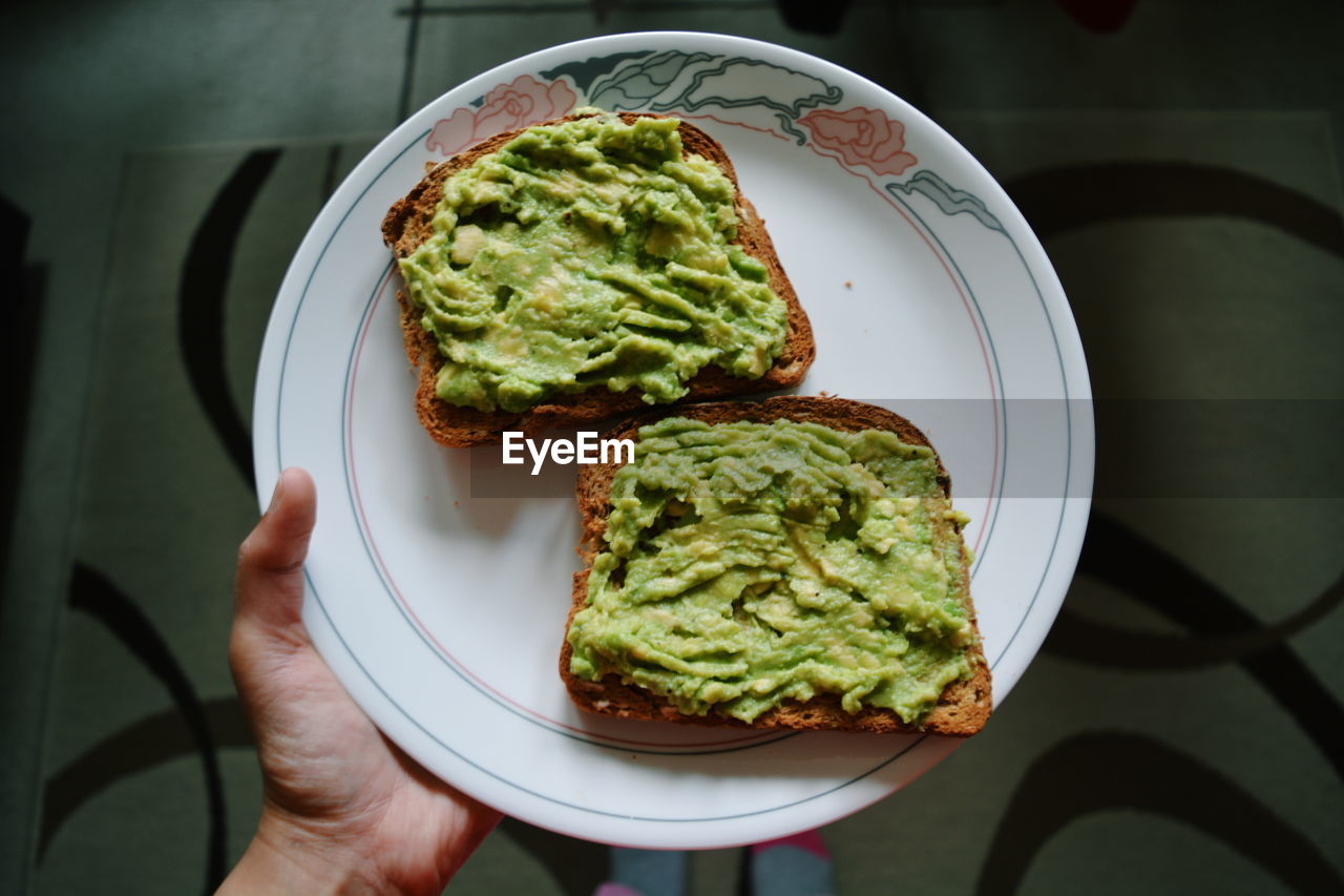 Cropped image of hand holding bread