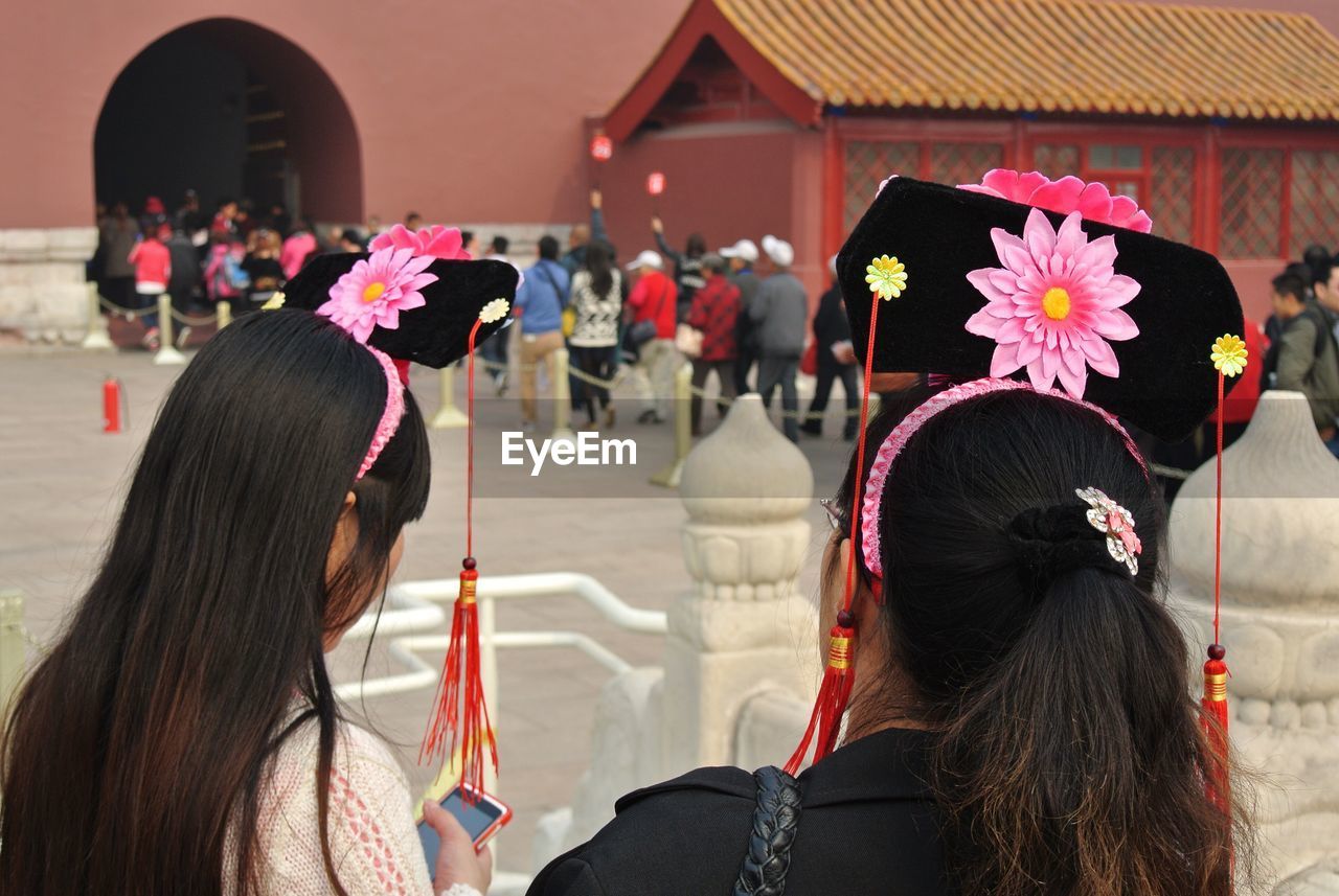 Rear view of women with headbands at forbidden city