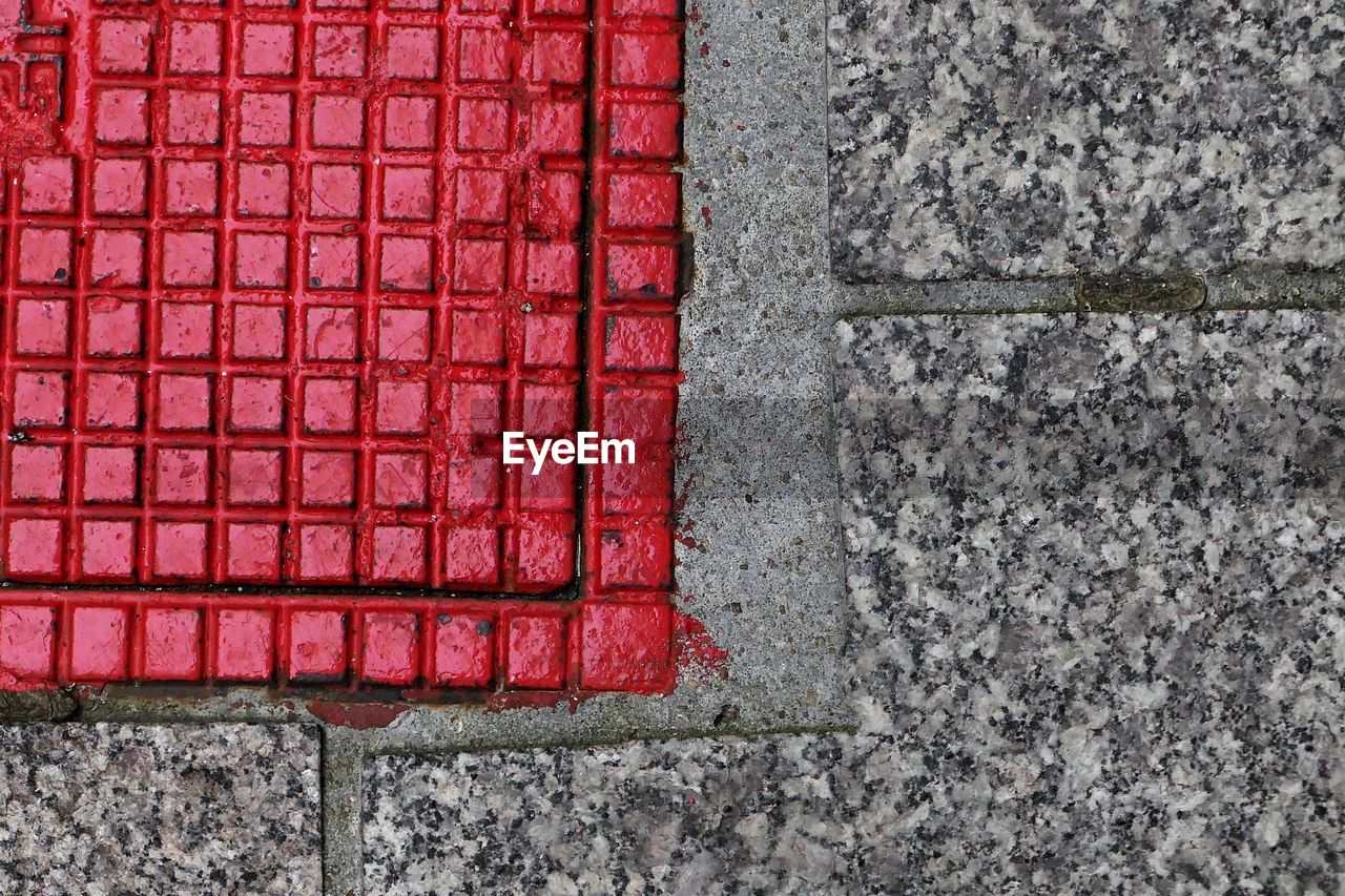 High angle view of red manhole on street