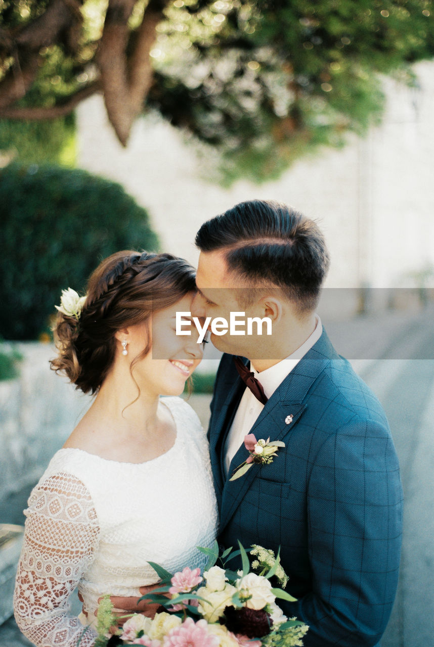 portrait of bride and bridegroom holding hands