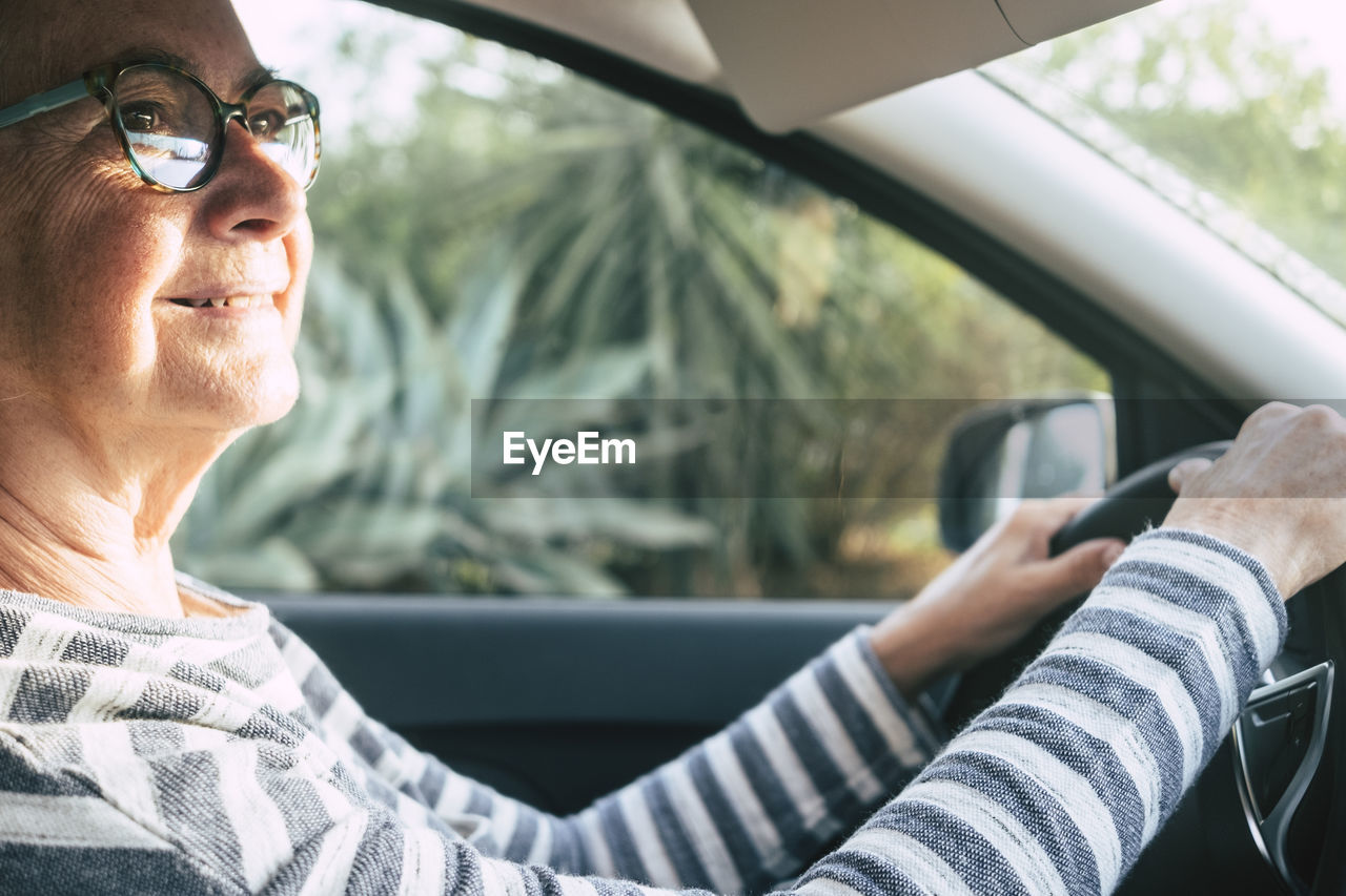 Midsection of man using mobile phone while sitting in car