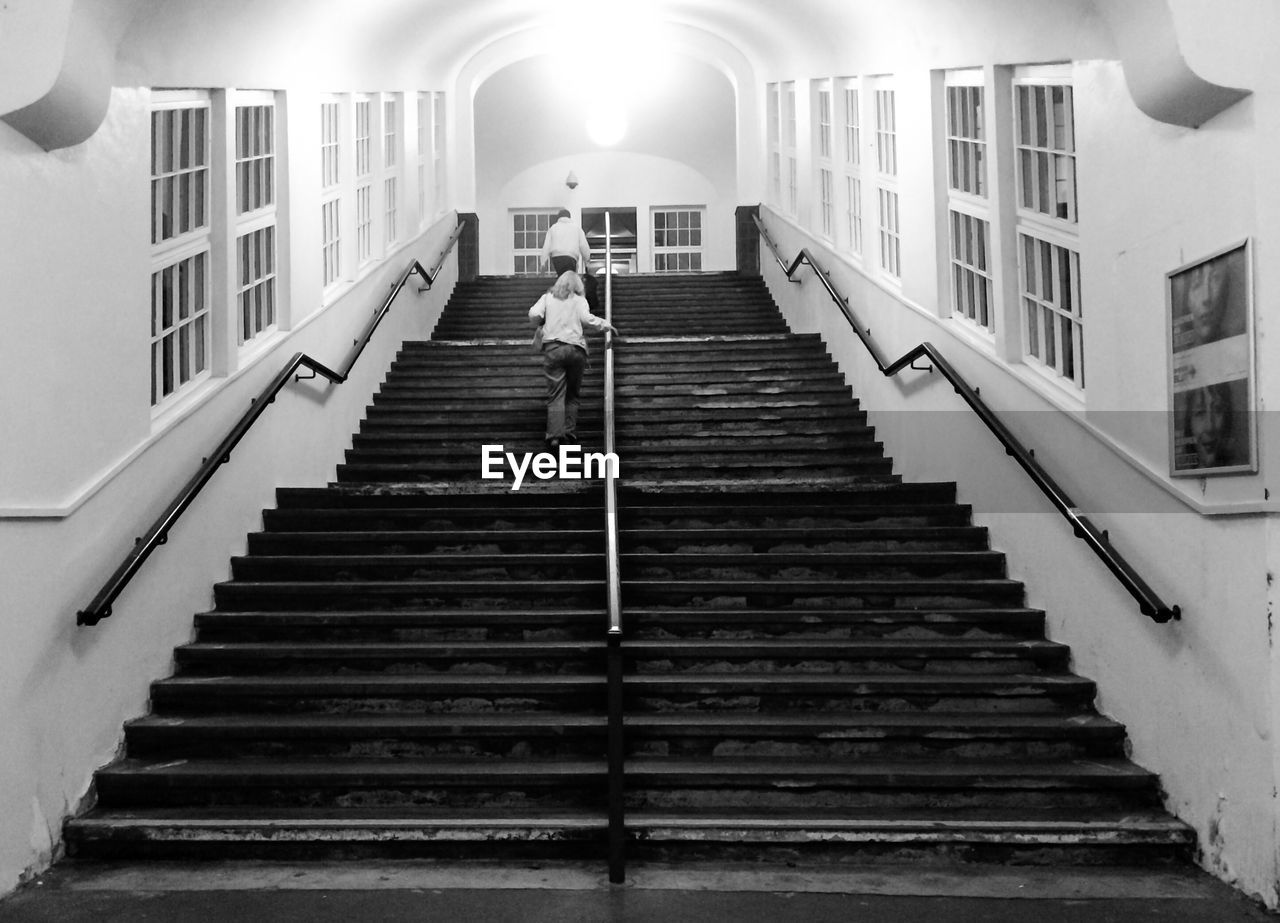 LOW ANGLE VIEW OF WOMAN WALKING ON STEPS