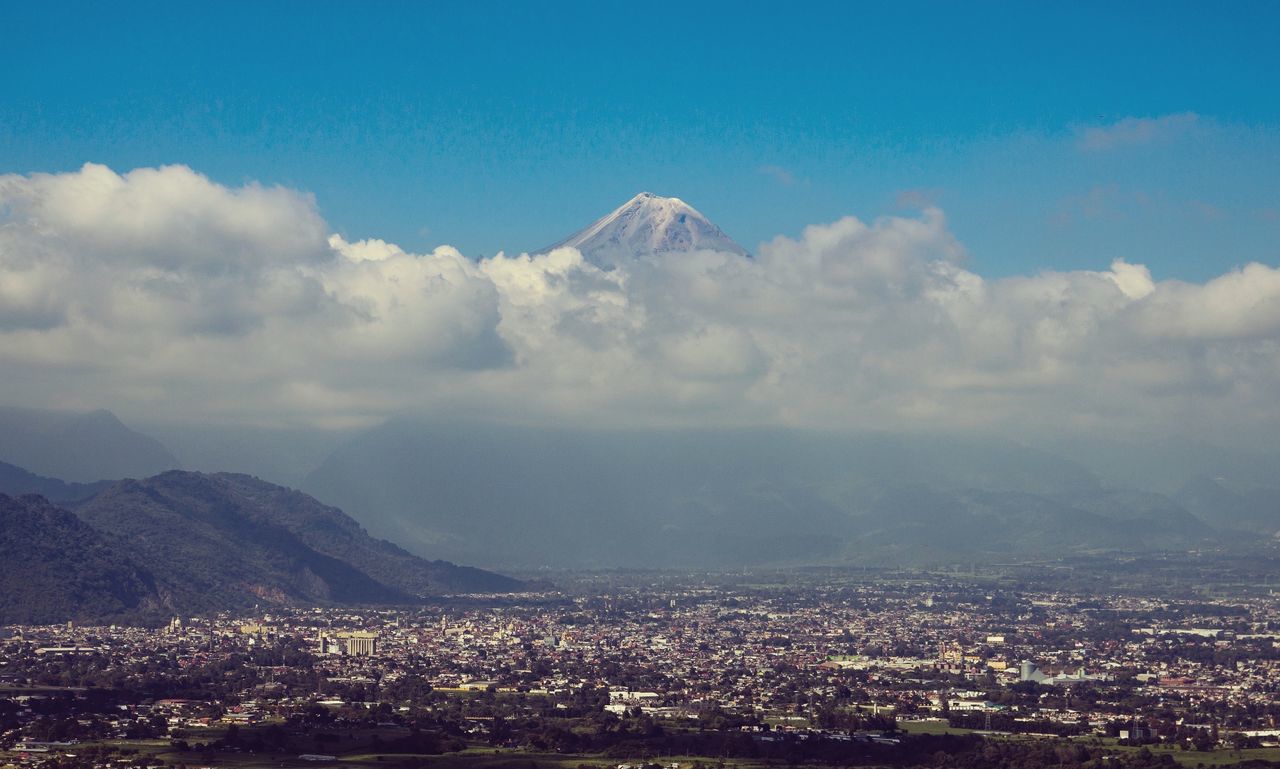 High angle view of cityscape against cloudy sky