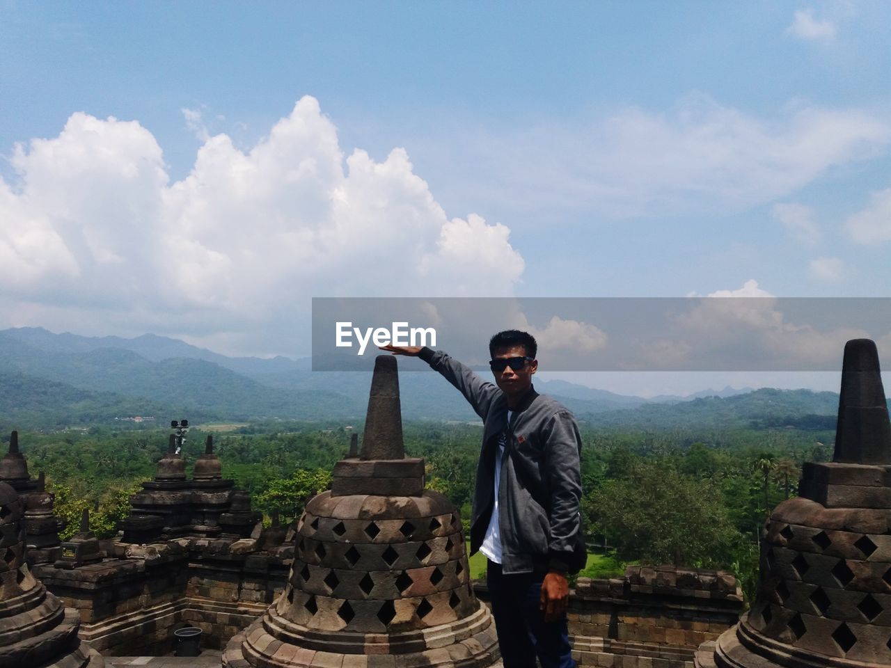 FULL LENGTH OF MAN STANDING ON MOUNTAIN