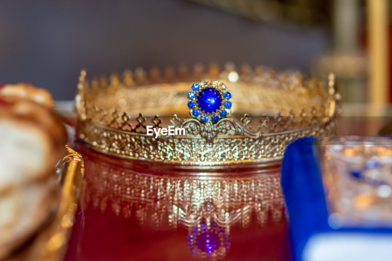 CLOSE-UP OF GLASSES ON TABLE AGAINST BLUE BACKGROUND