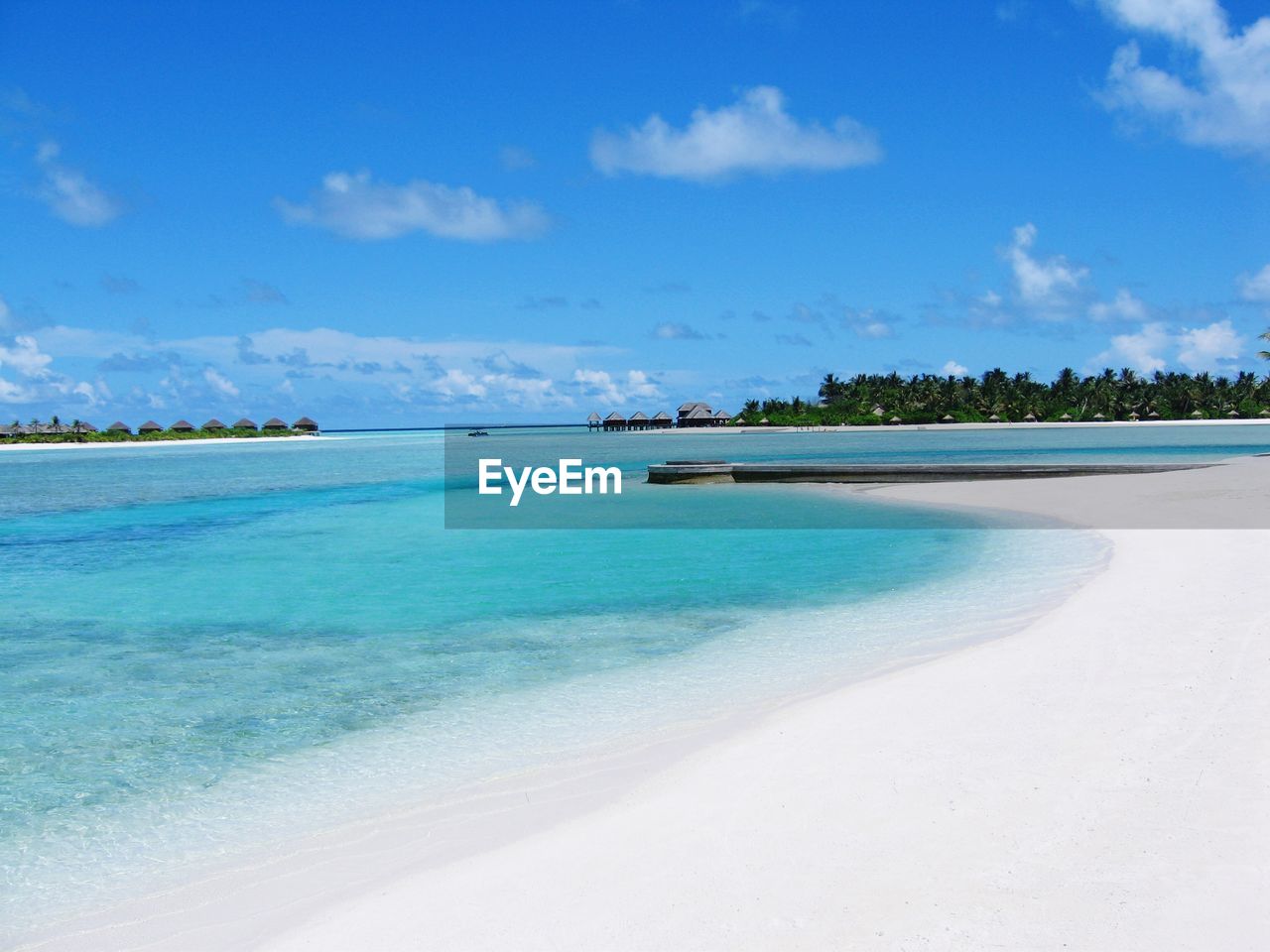 Scenic view of beach against blue sky