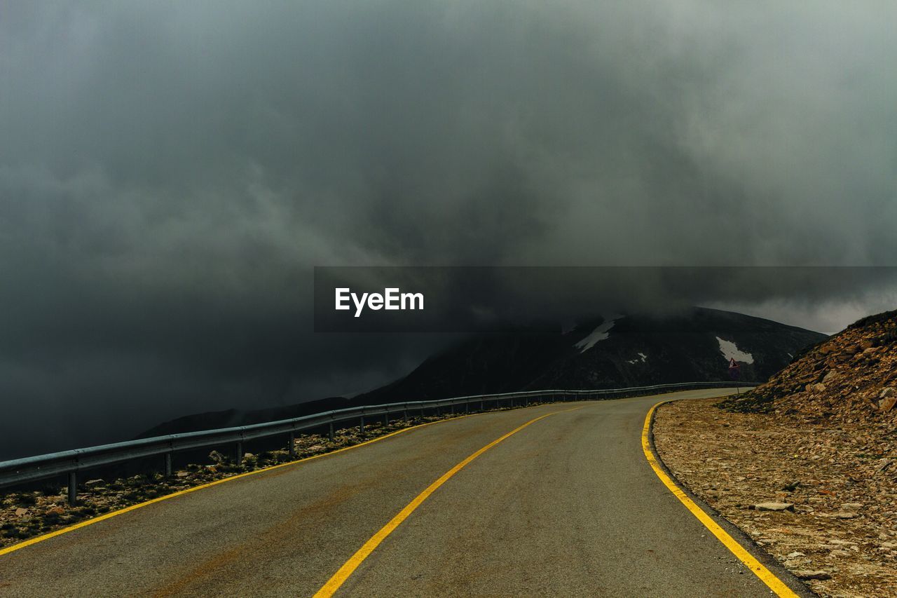 Road Sign Transportation Cloud - Sky Sky Direction The Way Forward Symbol Nature Road Marking No People Marking Non-urban Scene Beauty In Nature Storm Double Yellow Line Mountain Overcast Scenics - Nature Diminishing Perspective Outdoors Power In Nature Dividing Line Electrify Your Life View From Your Car Your Personal Delight