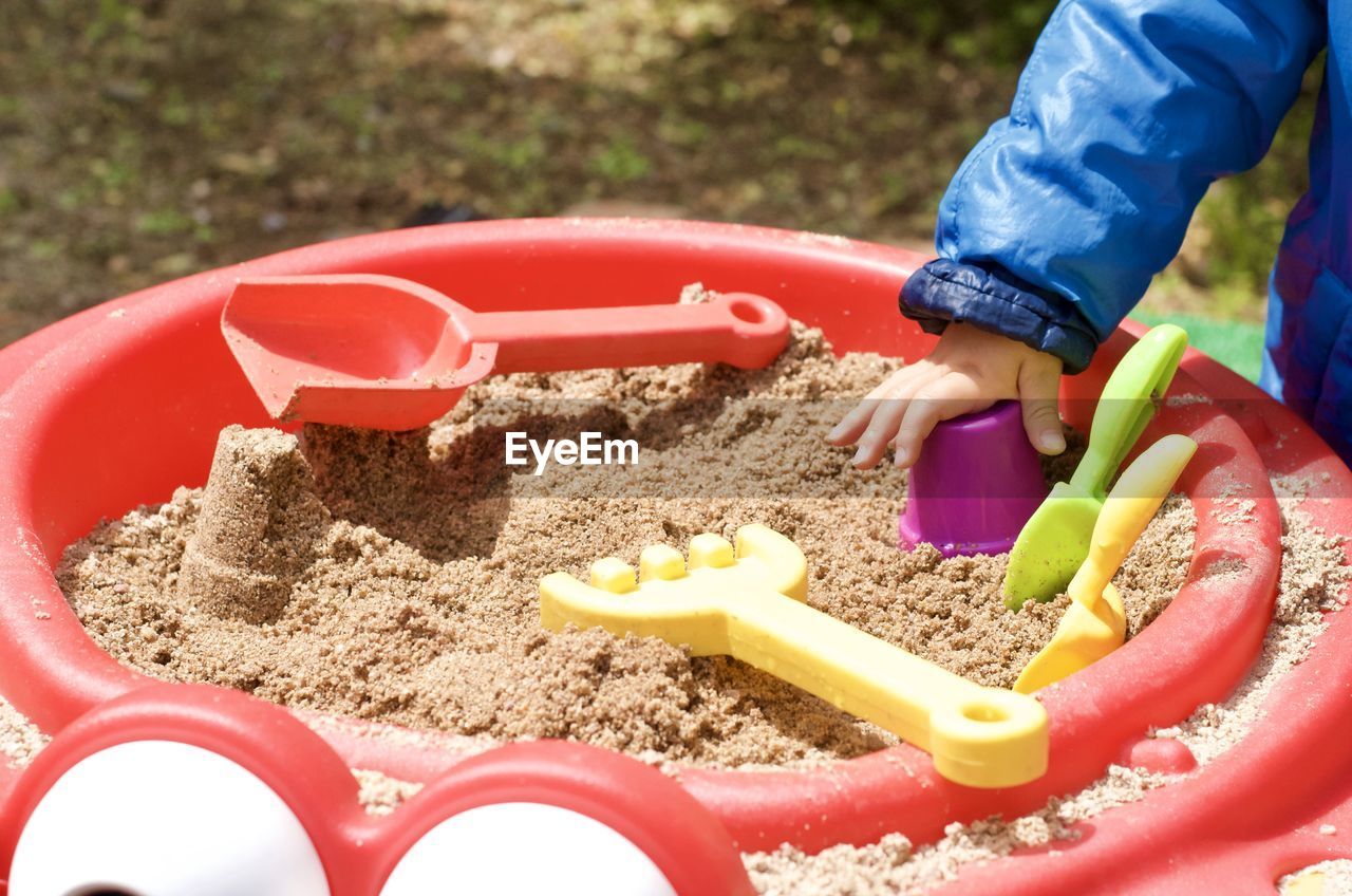 HIGH ANGLE VIEW OF BABY PLAYING WITH TOY