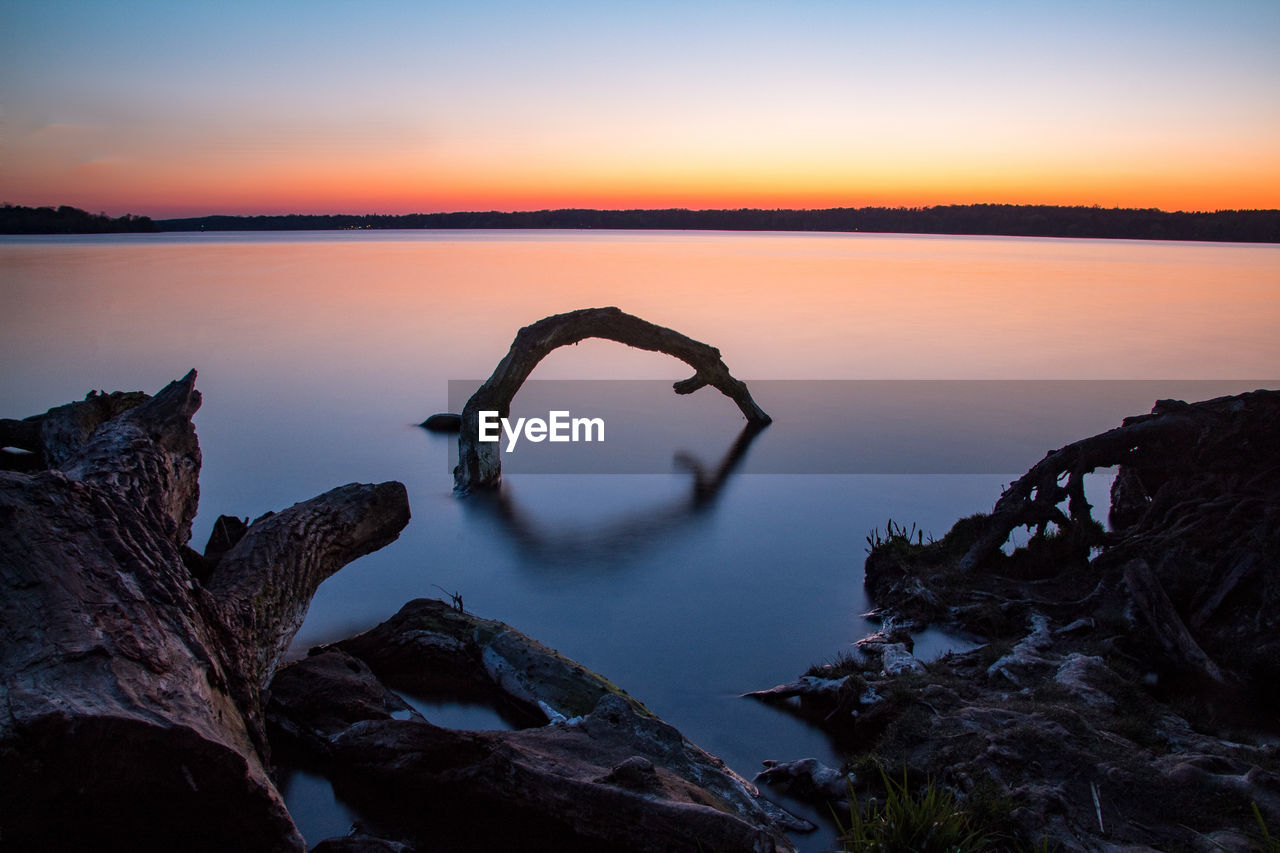 Scenic view of lake against sky during sunset