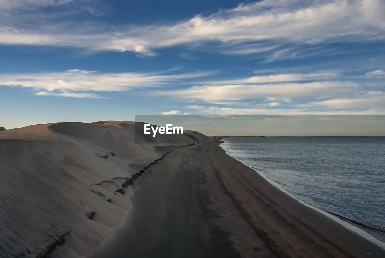 The late afternoon sun casts shadows across the sand dunes at adolfo lopez mateos in baja california