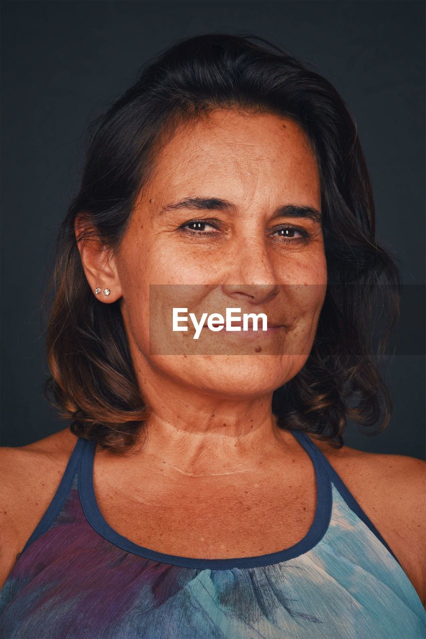 CLOSE-UP PORTRAIT OF A SMILING WOMAN WITH HAIR