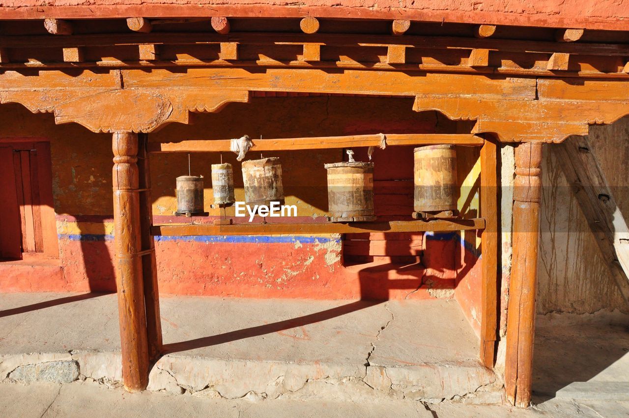 Prayer wheels in temple on sunny day