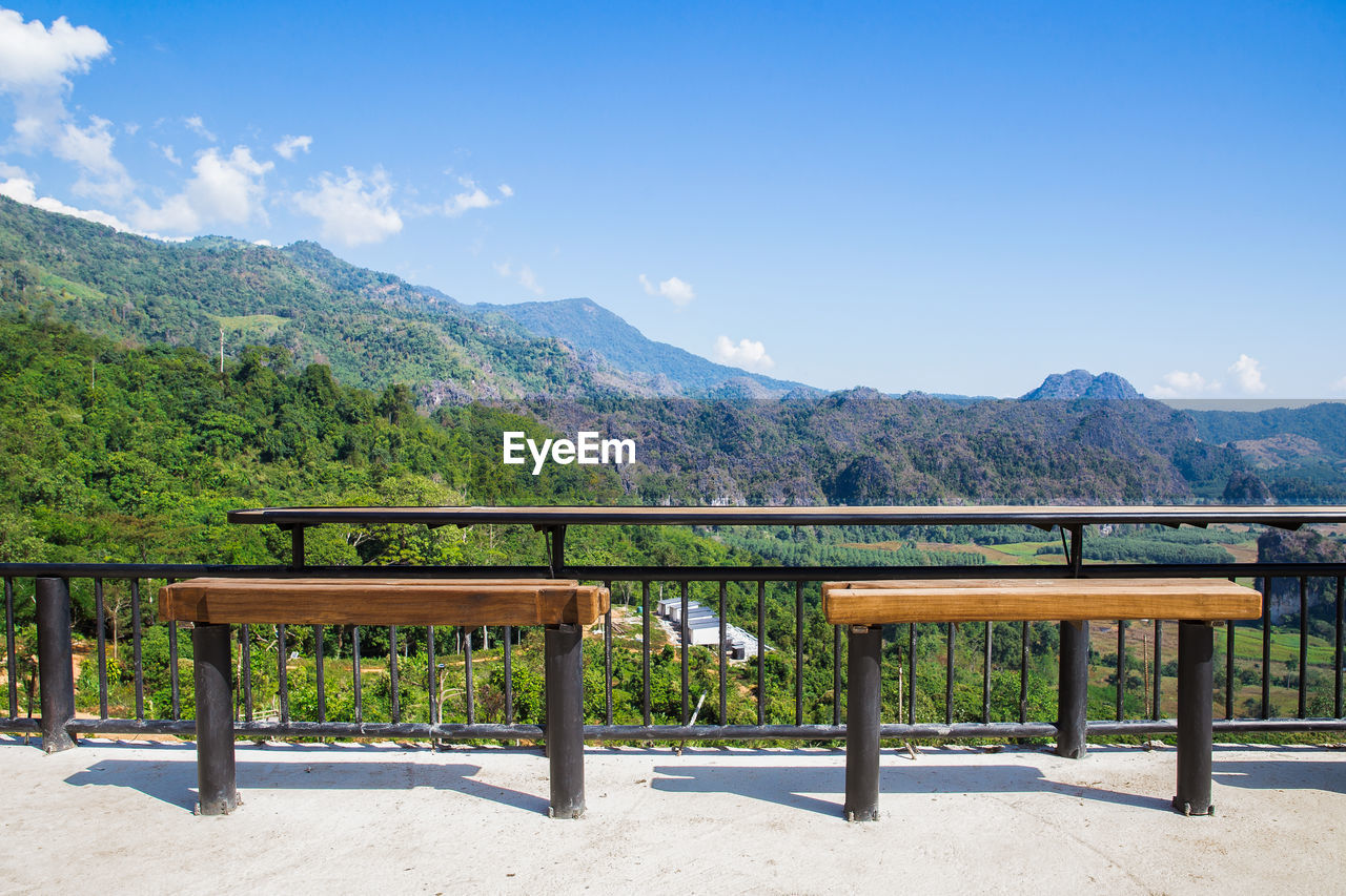 BENCH AND TABLE AGAINST MOUNTAINS