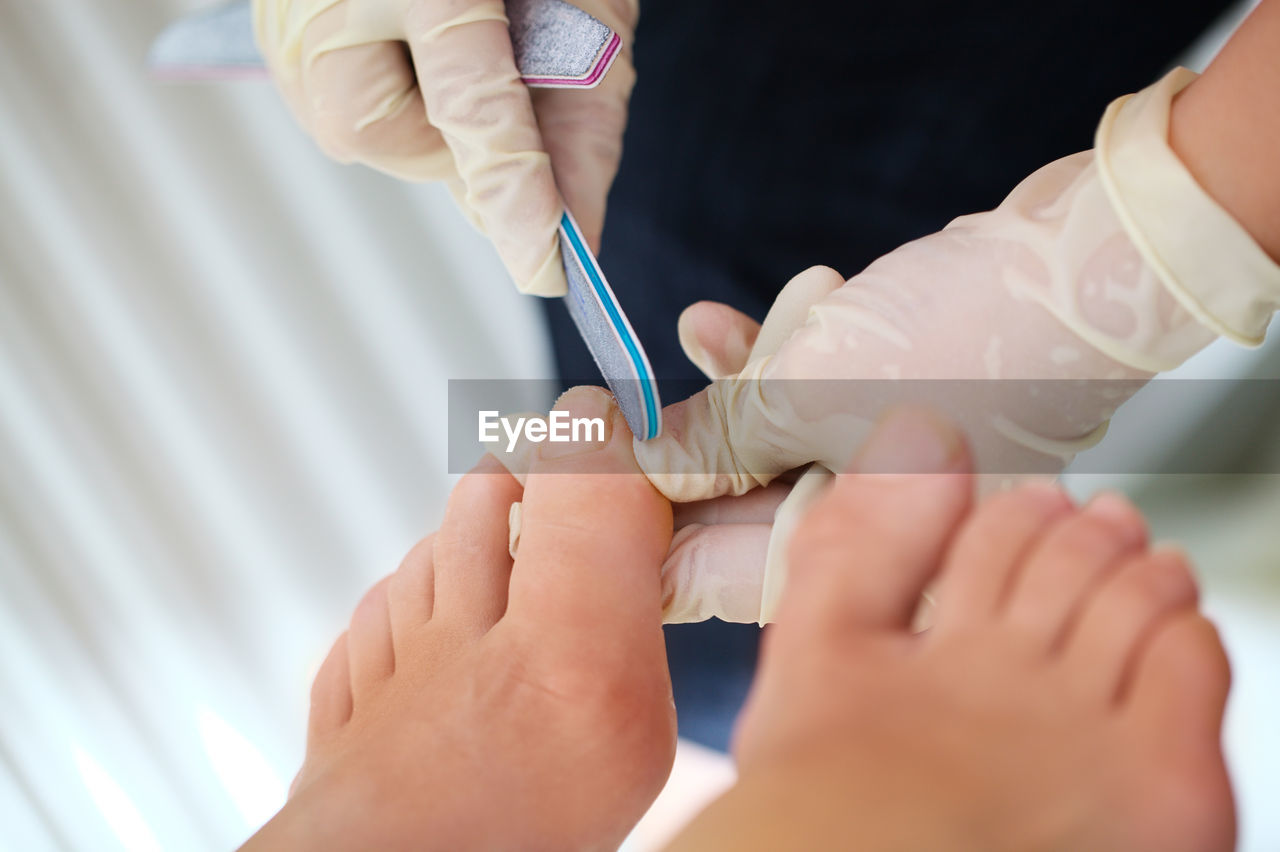 Woman getting pedicure at nail salon