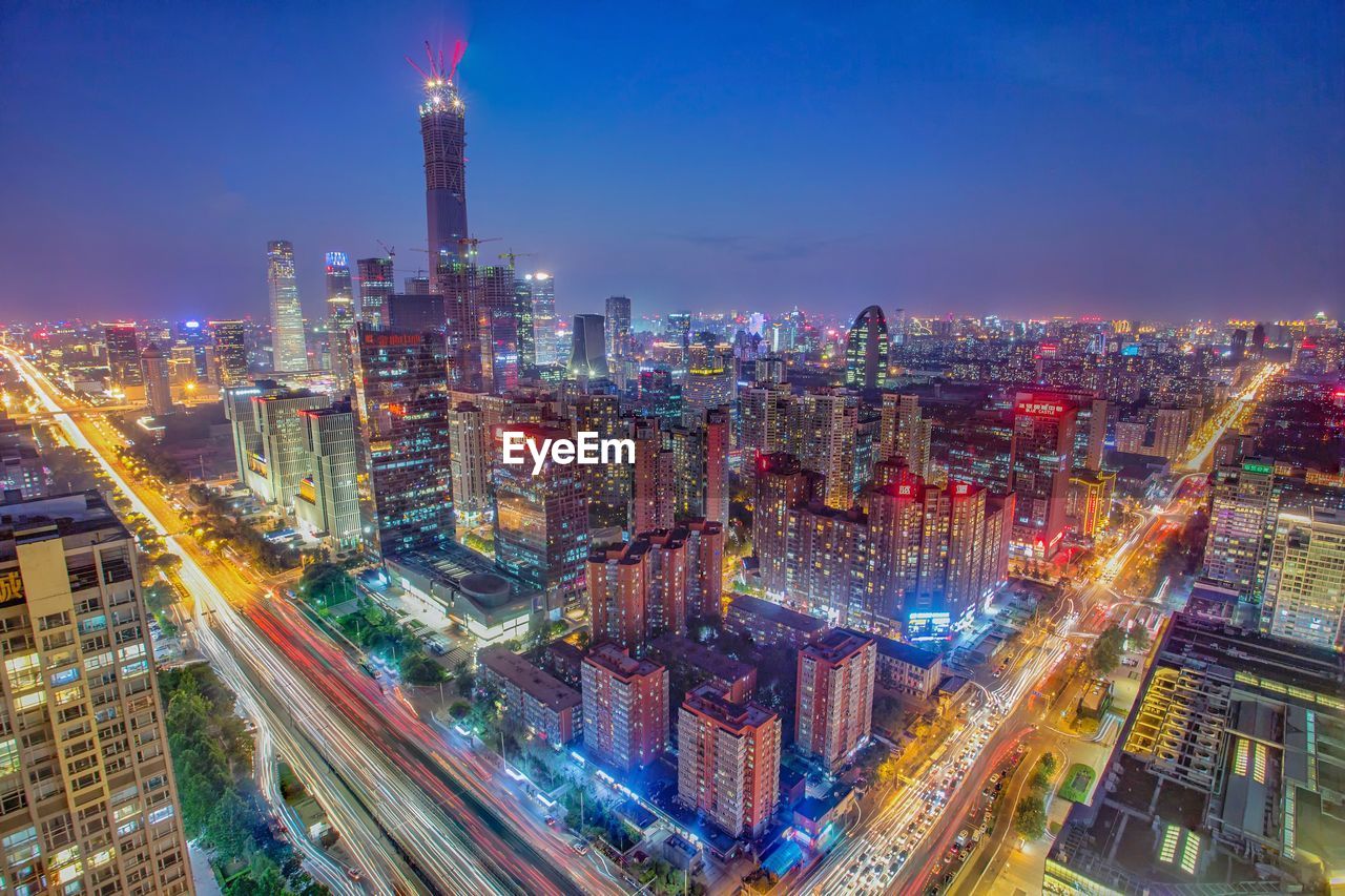 High angle view of illuminated buildings in city at night