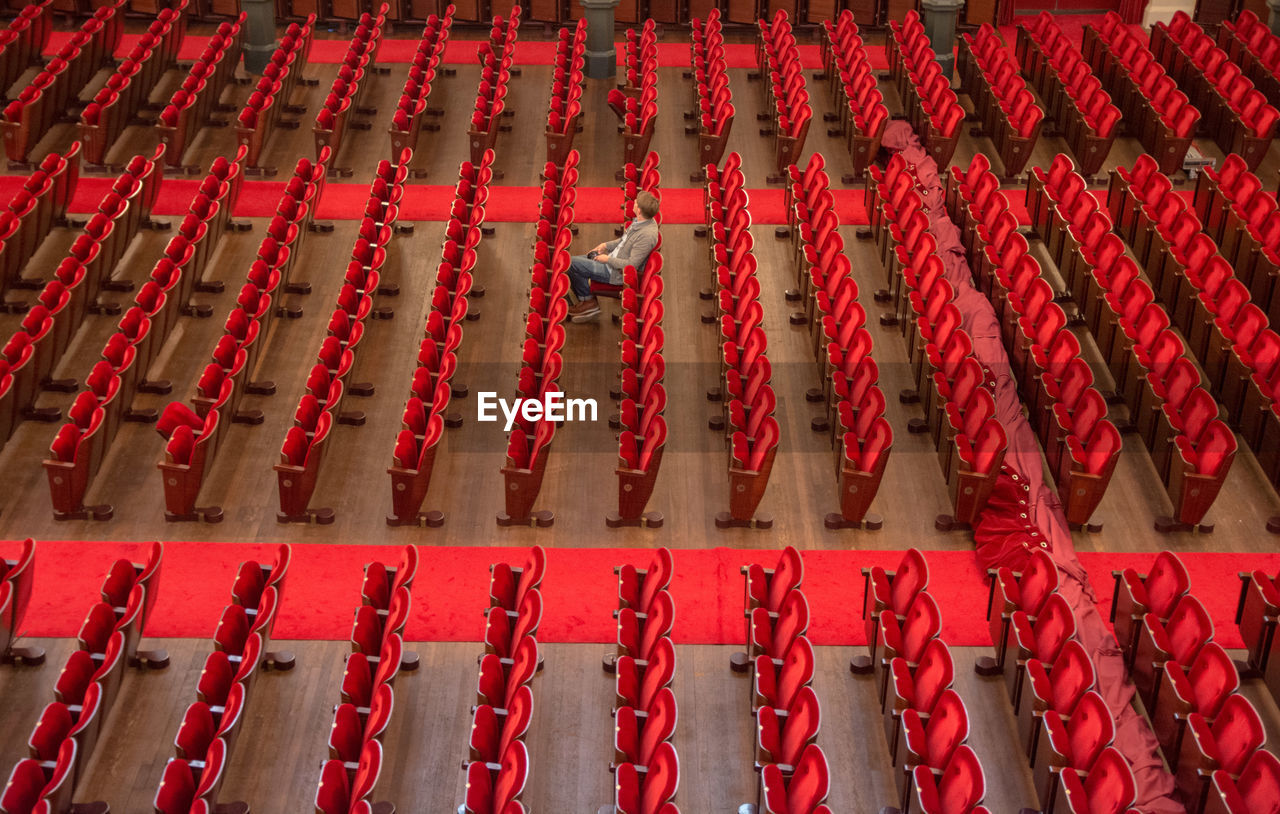 High angle view of man sitting on chair in opera house