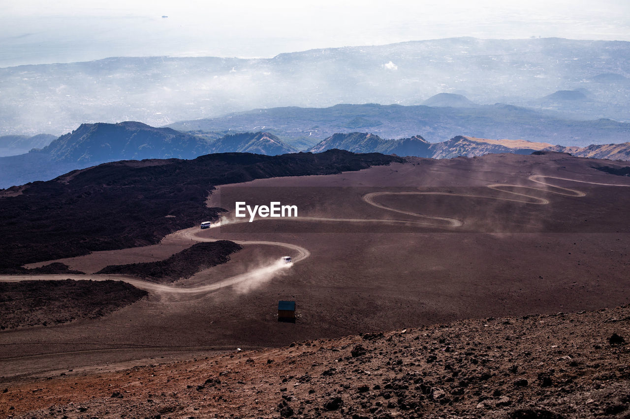 High angle view of road by mountains against sky