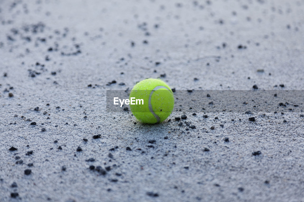 Abandoned tennis ball in schoolyard