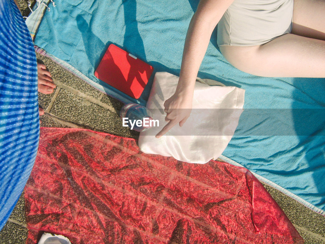 HIGH ANGLE VIEW OF WOMAN LYING IN BED